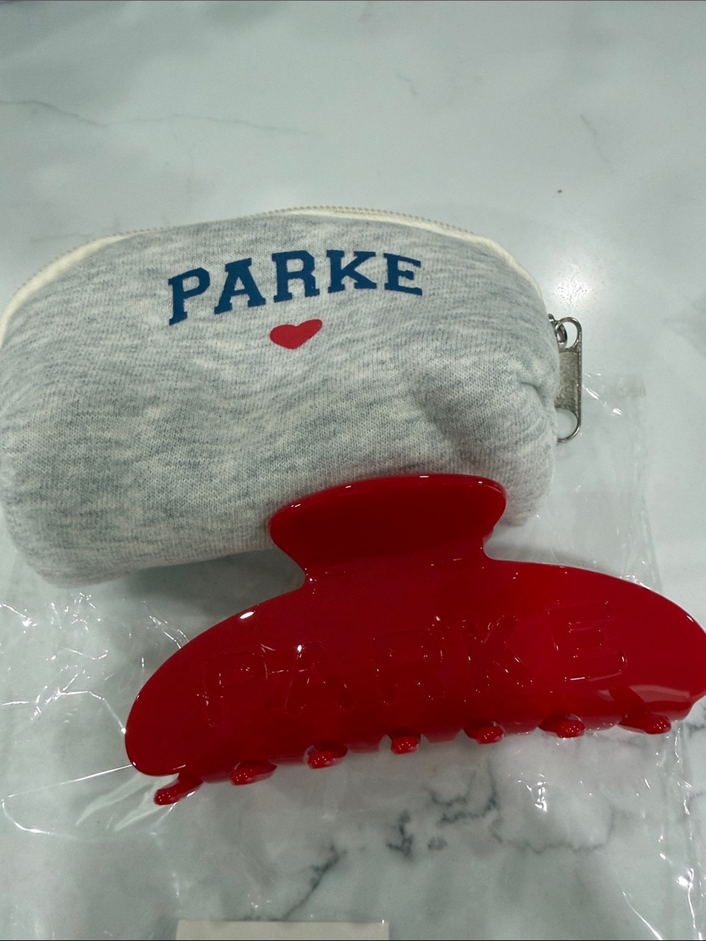 New in bag Parke red crimson hair claw clip with Grey Pouch